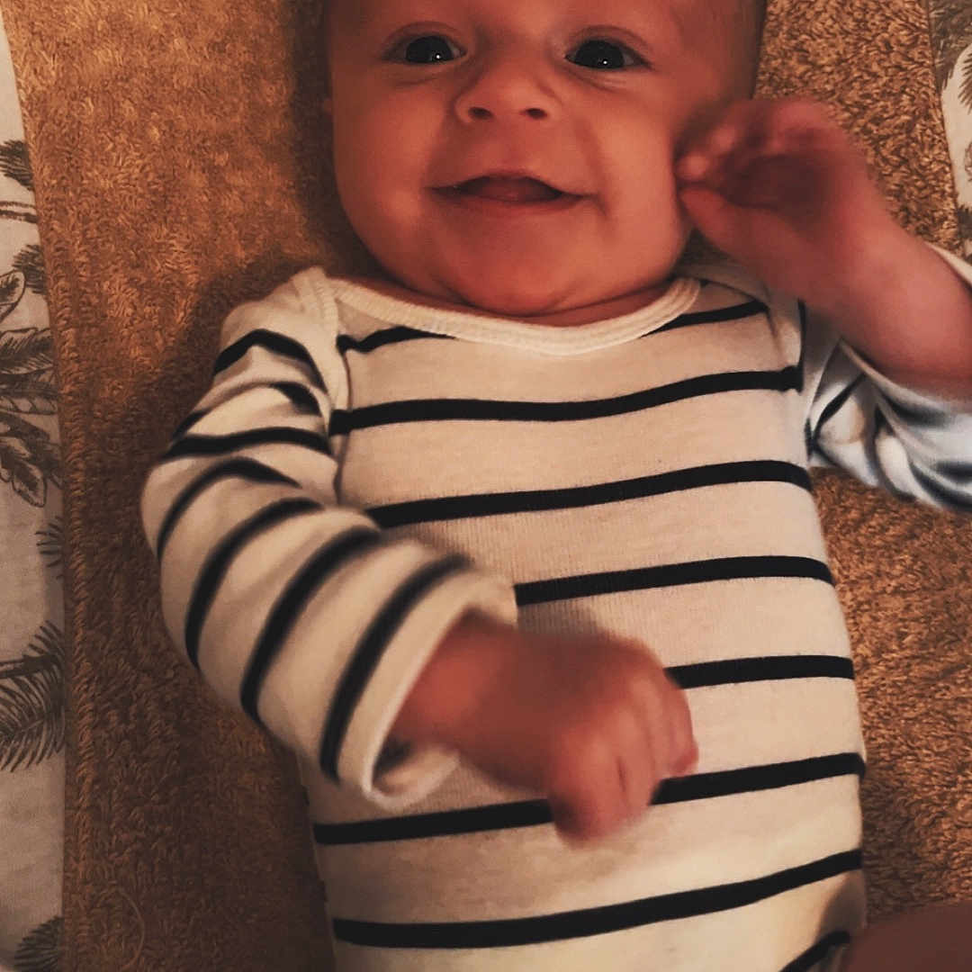 Milan participe au concours pour gagner de l'argent avec cette photo : baby, bodypart, clothing, couch, cushion, face, finger, furniture, hand, happy, head, homedecor, laughing, newborn, person, photography, portrait, sitting, smile, t_shirt