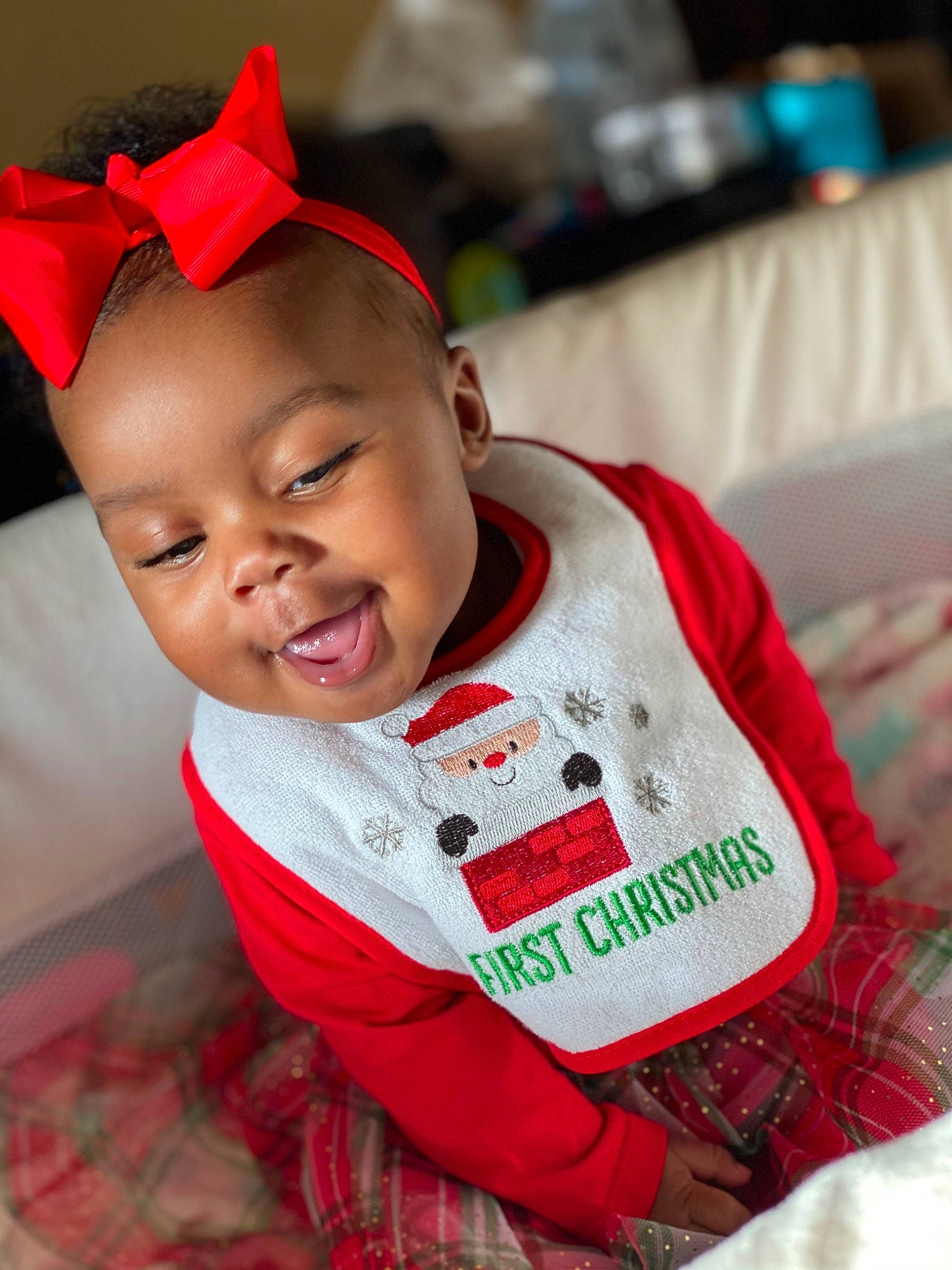 Carlee is registered to the contest to win money with this photo: baby, baby_toddler_clothing, carmine, child, christmas, costume_accessory, costume_hat, hair_accessory, headband, joy, lip, person, plaid, red, tartan, toddler, tongue