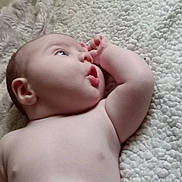 Paxton is registered to the contest to win money with this photo: baby, infant, skin, blanket, texture, soft, lying_down, curious, expression, face, arm, hand, indoors, closeup, child, newborn, resting, peaceful, portrait, natural_light