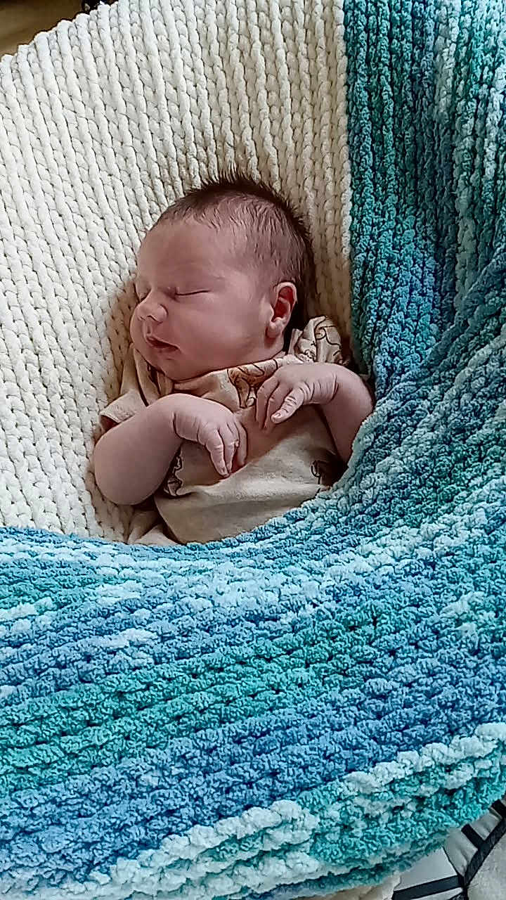 Paxton is registered to the contest to win money with this photo: baby, newborn, sleeping, blanket, knit_blanket, cozy, infant, child, soft_texture, blue, cream, teal, resting, cute, small_hands, wrapped, portrait, indoors, peaceful, comfort