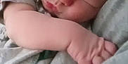 Paxton is registered to the contest to win money with this photo: baby, sleeping, close_up, arm, soft_lighting, peaceful, infant, face, skin, hand, comfort, rest, cuddle, blanket, clothing, person, indoors, cute, newborn, tender
