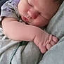 Paxton is registered to the contest to win money with this photo: baby, sleeping, close_up, arm, soft_lighting, peaceful, infant, face, skin, hand, comfort, rest, cuddle, blanket, clothing, person, indoors, cute, newborn, tender