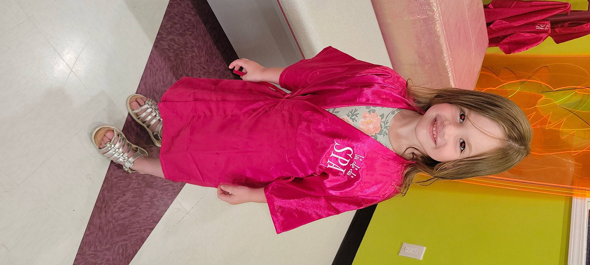 Delilah is registered to the contest to win money with this photo: carmine, child, comfort, elbow, flooring, fun, human_leg, joint, joy, knee, magenta, pattern, person, pink, purple, room, sitting, sleeve, smile, thigh