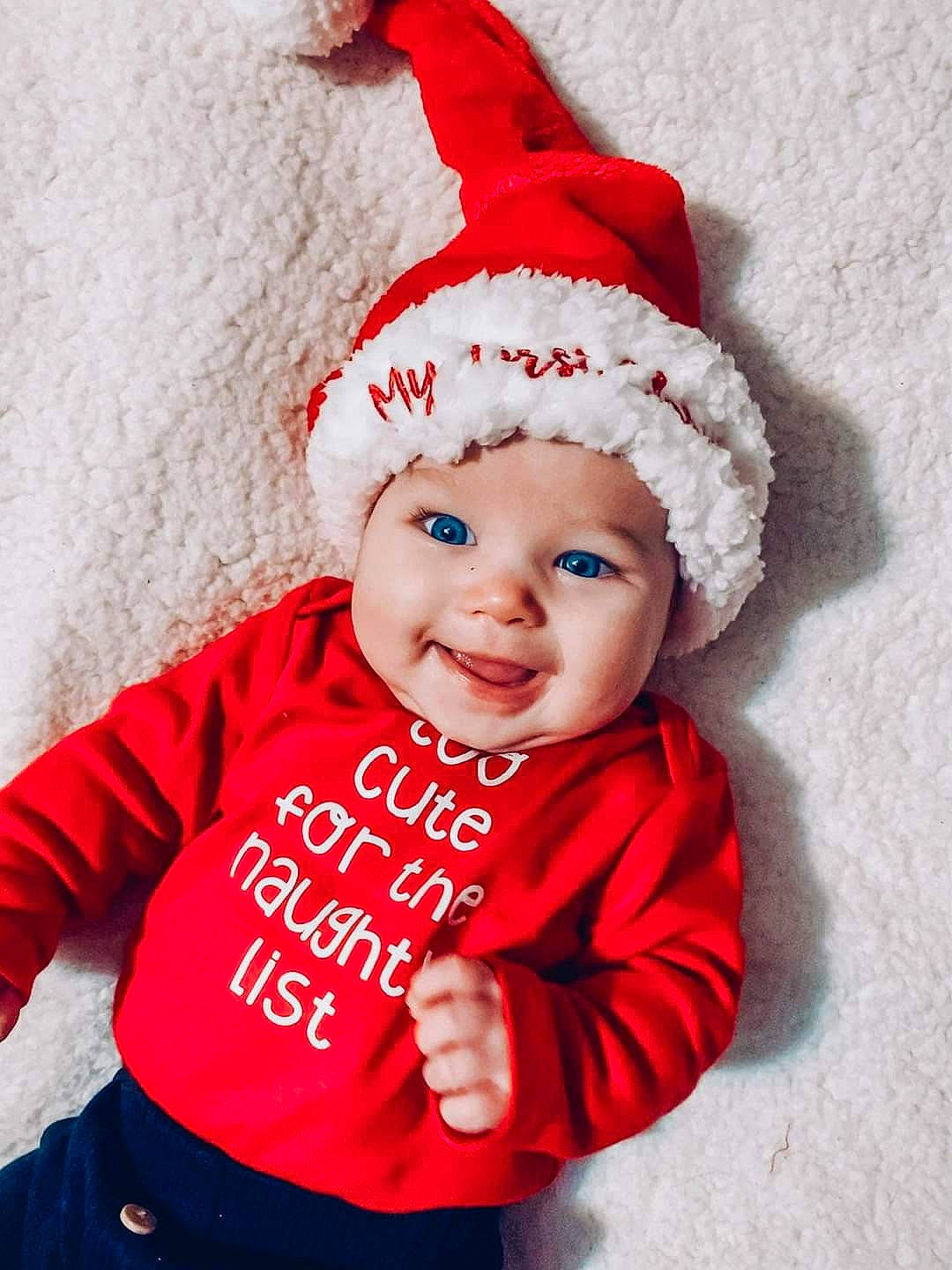 Azlyn is registered to the contest to win money with this photo: baby_toddler_clothing, cap, christmas_decoration, christmas_ornament, clothing, costume_hat, event, face, happy, hat, headgear, headwear, holiday, human_body, joy, outerwear, person, pink, red, sleeve