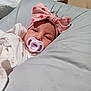 Jazmine Serenity is registered to the contest to win money with this photo: baby, bedroom, blanket, clothing, comfort, cozy, cushion, cute, headband, indoors, infant, pacifier, person, pink, portrait, resting, sleepy, soft, strawberry_pattern, young_child