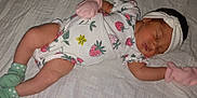 Jazmine Serenity is registered to the contest to win money with this photo: baby, blanket, child, cute, green, headband, indoors, infant, lying_down, mittens, newborn, onesie, peaceful, pink, portrait, sleeping, socks, soft_texture, strawberry_pattern, white