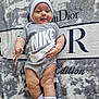 Muna joined the competition — help win amazing prizes! baby, infant, smiling, clothing, onesie, hat, socks, blanket, logo, nike, dior, soft_texture, lying_down, cute, happy, indoors, person, portrait, baby_leg, baby_hand