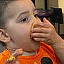 toddler, child, messy, food, orange_shirt, mickey_mouse, hands, face, eating, indoor, closeup, cute, happy, meal_time, casual, young_child, clothing, person, portrait, dirt