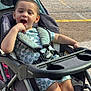 toddler, stroller, child, outdoor, smiling, sunlight, happy, clothing, seatbelt, playful, person, baby, transport, casual, summer, young_child, sitting, daytime, expression, fun