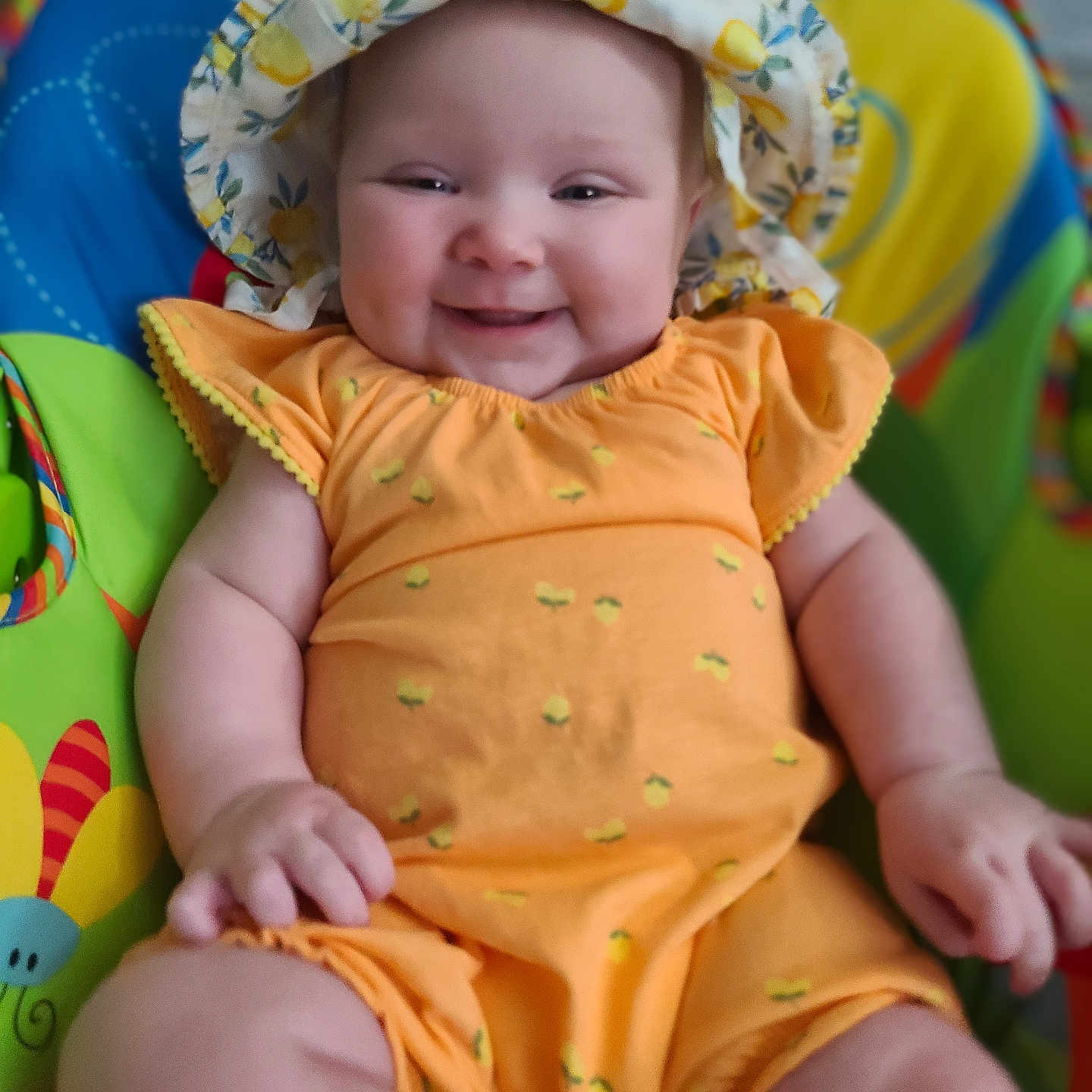Fern is registered to the contest to win money with this photo: baby, babylaughing, bodypart, bonnet, cap, clothing, dress, face, finger, hand, happy, hat, head, newborn, person, photography, portrait, sitting, smile, sunhat