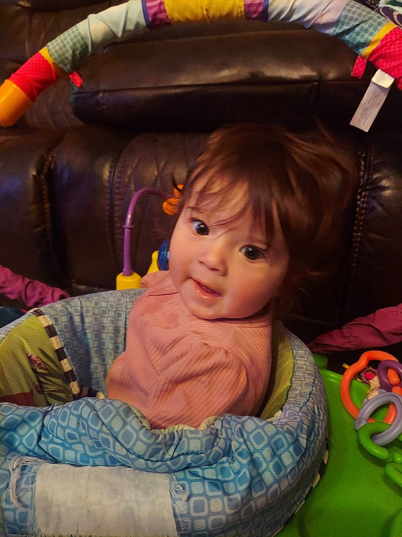 Brinley is registered to the contest to win money with this photo: baby_carriage, cheek, child, comfort, cool, eye, face, facial_expression, fun, hair, hairstyle, head, human, iris, mouth, person, product, purple, skin, textile