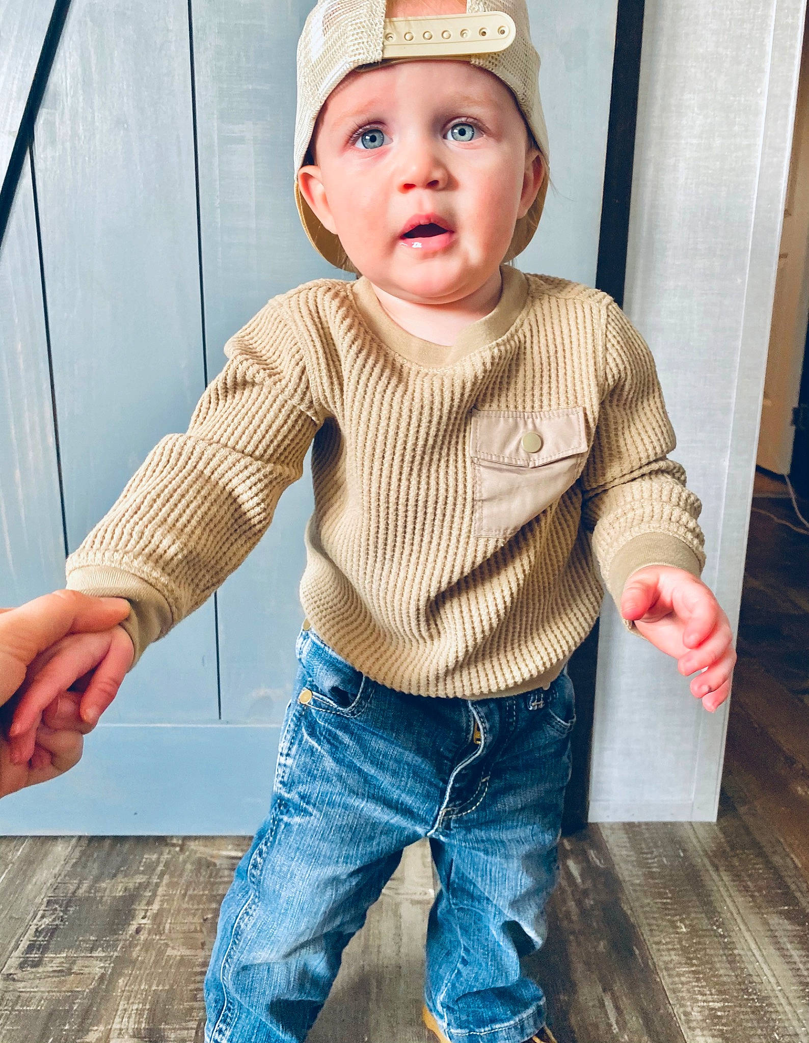 Kohen is registered to the contest to win money with this photo: baby_toddler_clothing, collar, cool, dress_shirt, eyelash, eyewear, gesture, hat, head, headwear, jeans, lip, orange, person, plaid, skin, sleeve, standing, street_fashion, surprise