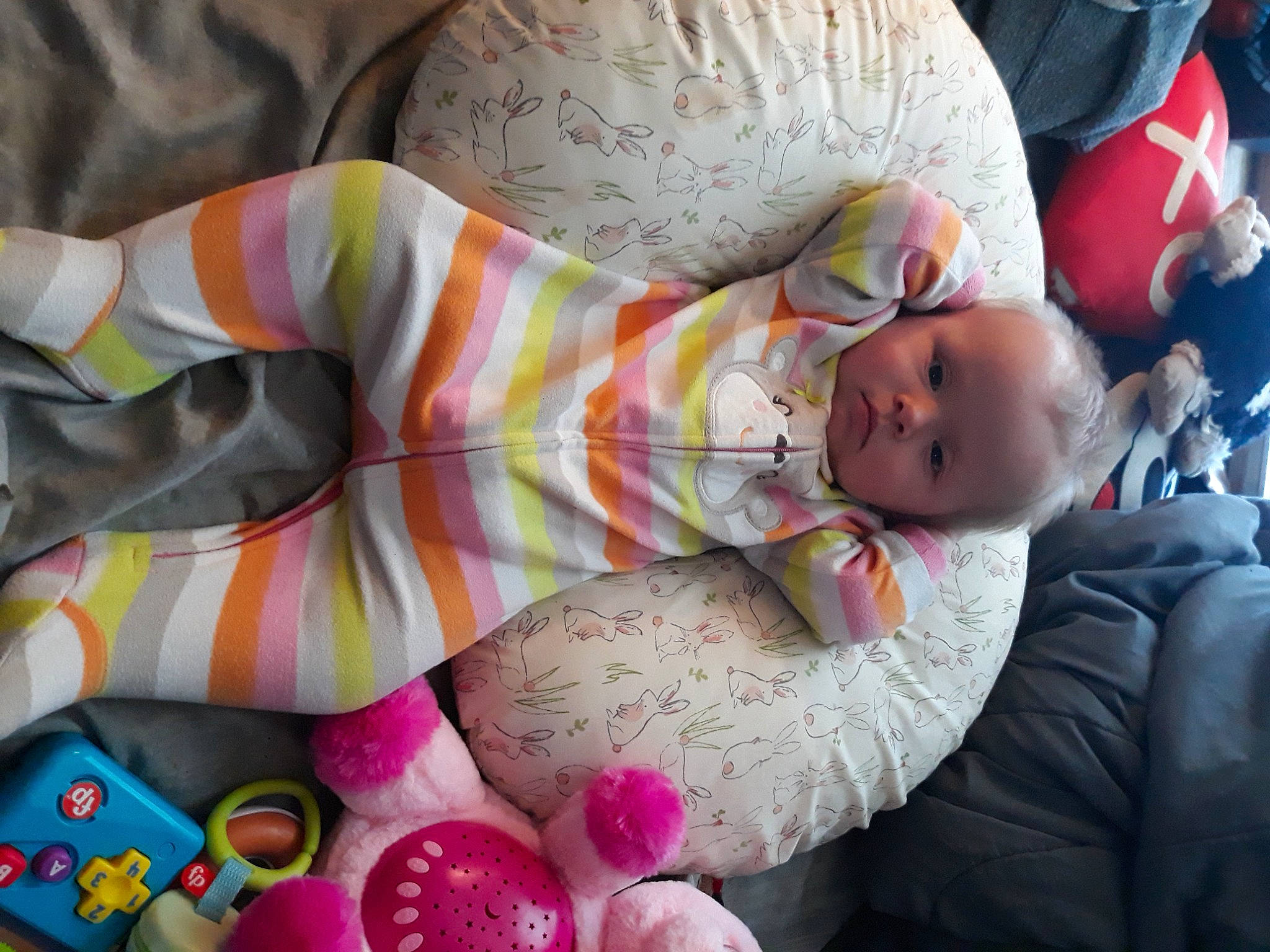 Charlotte joined the competition — help win amazing prizes! baby, baby_products, baby_toddler_clothing, child, comfort, couch, hat, human_leg, lap, linens, nap, pattern, person, product, room, sitting, textile, thigh, toddler, toy