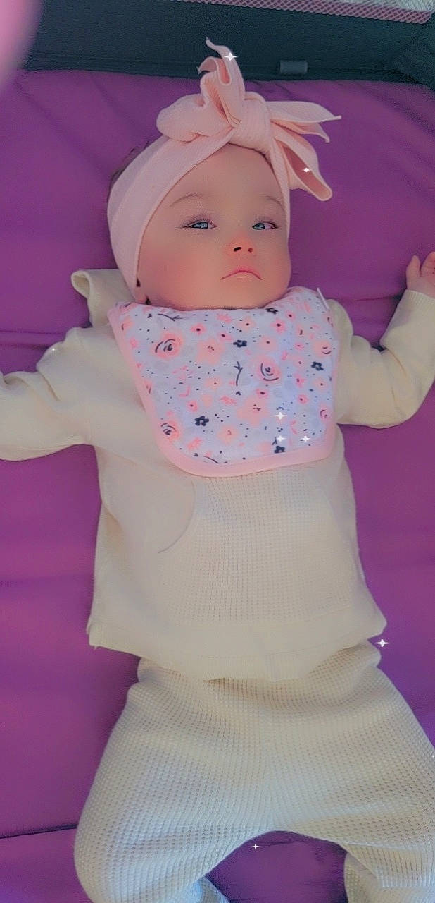 Braelyn joined the competition — help win amazing prizes! baby, baby_toddler_clothing, cap, cheek, child, doll, eye, head, headwear, lip, magenta, outerwear, pattern, person, pink, purple, sleeve, textile, toddler, trunk