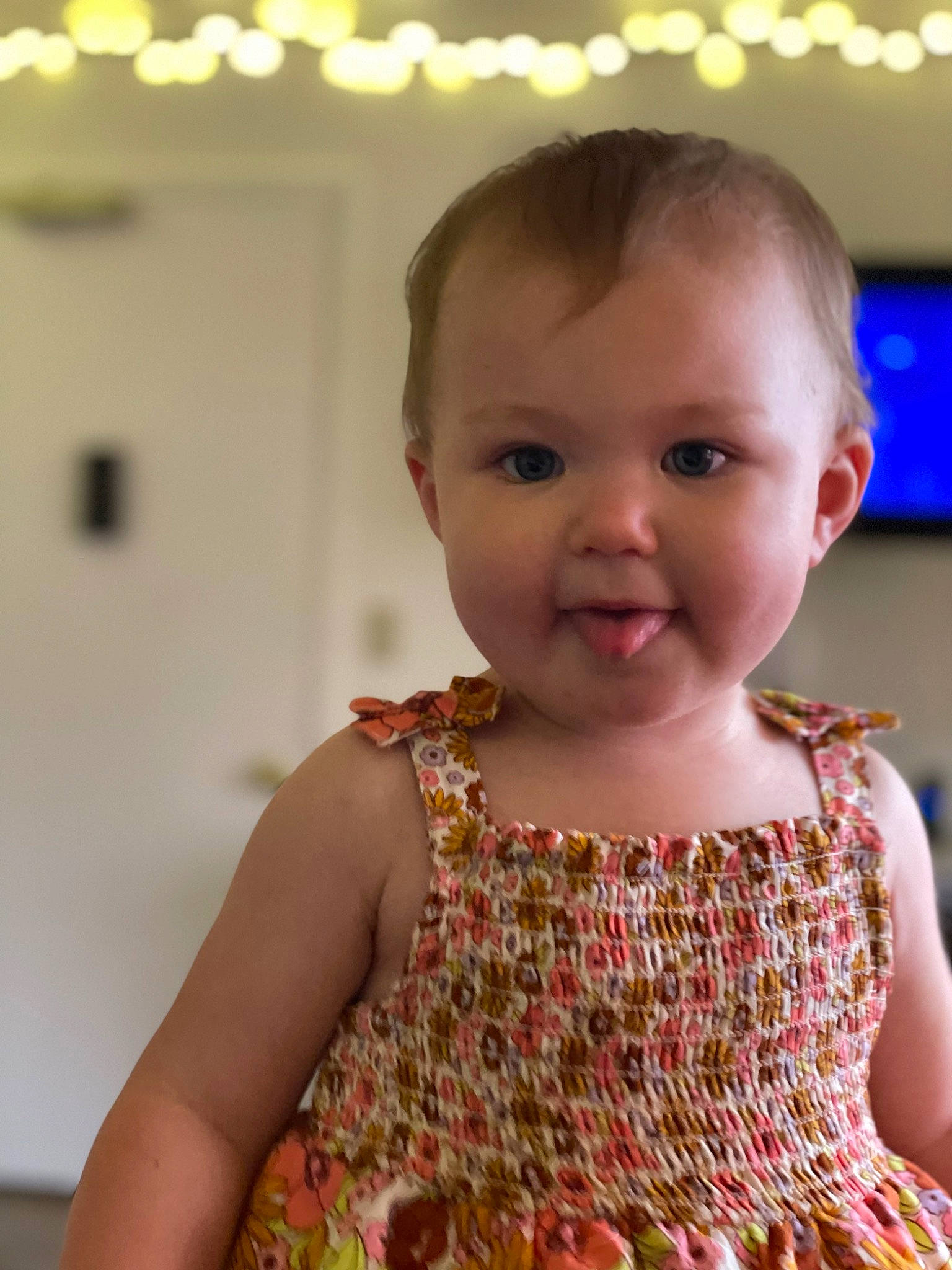 Esmeray is registered to the contest to win money with this photo: baby, baby_toddler_clothing, cheek, child, day_dress, dress, embellishment, event, fun, happy, iris, pattern, peach, person, skin, sleeve, smile, standing, t_shirt, television