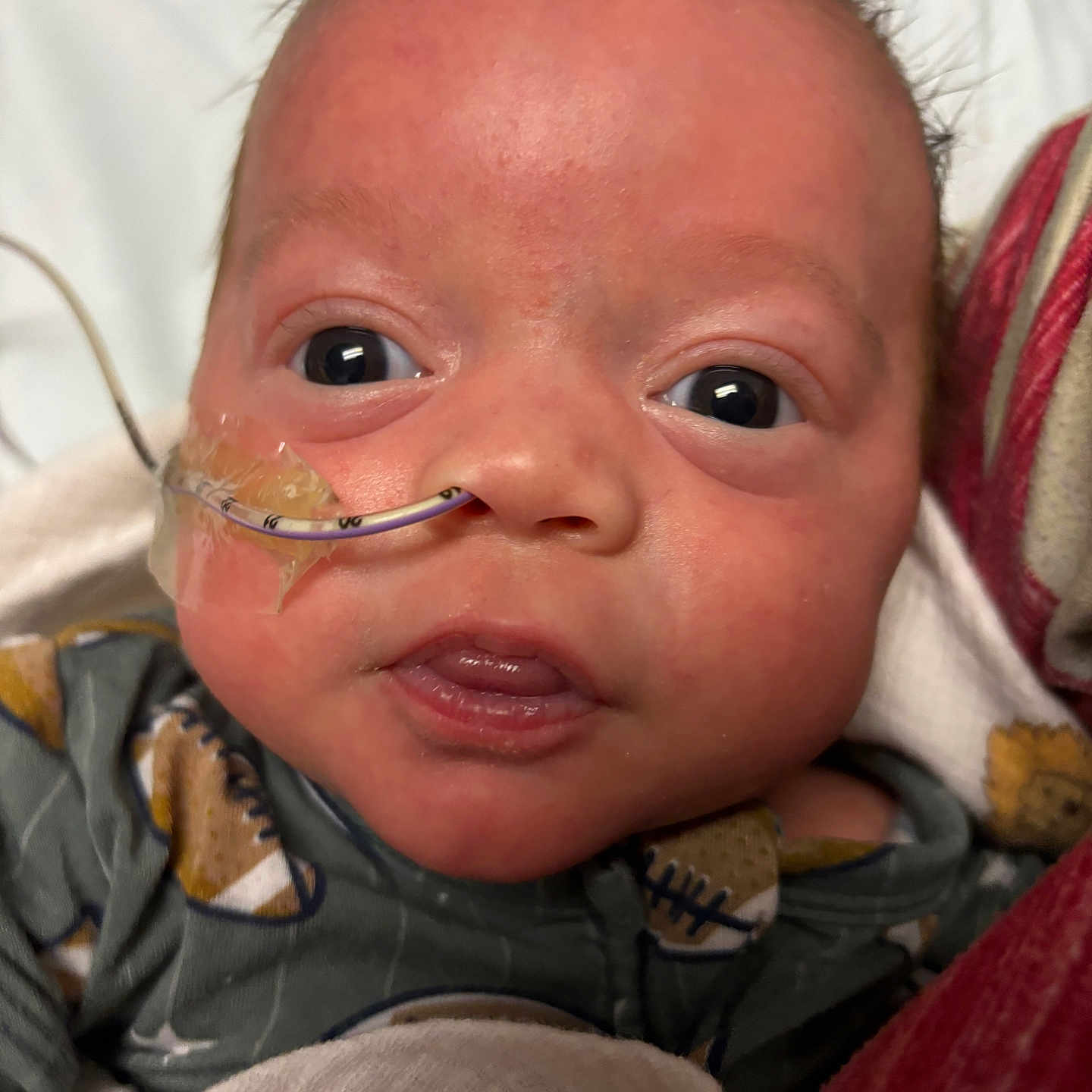 James is registered to the contest to win money with this photo: architecture, baby, bodypart, building, couch, face, finger, frown, furniture, hand, happy, head, hospital, mouth, newborn, person, photography, portrait, sad, smile