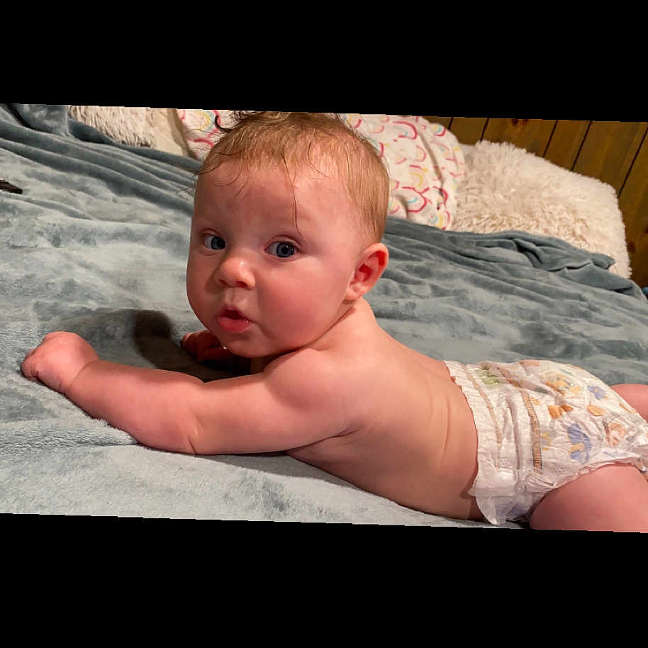 Kinsley is registered to the contest to win money with this photo: baby, back, bed, bedroom, bodypart, crawling, diaper, face, finger, furniture, hand, head, indoors, newborn, person, photography, portrait, quilt, room, sitting