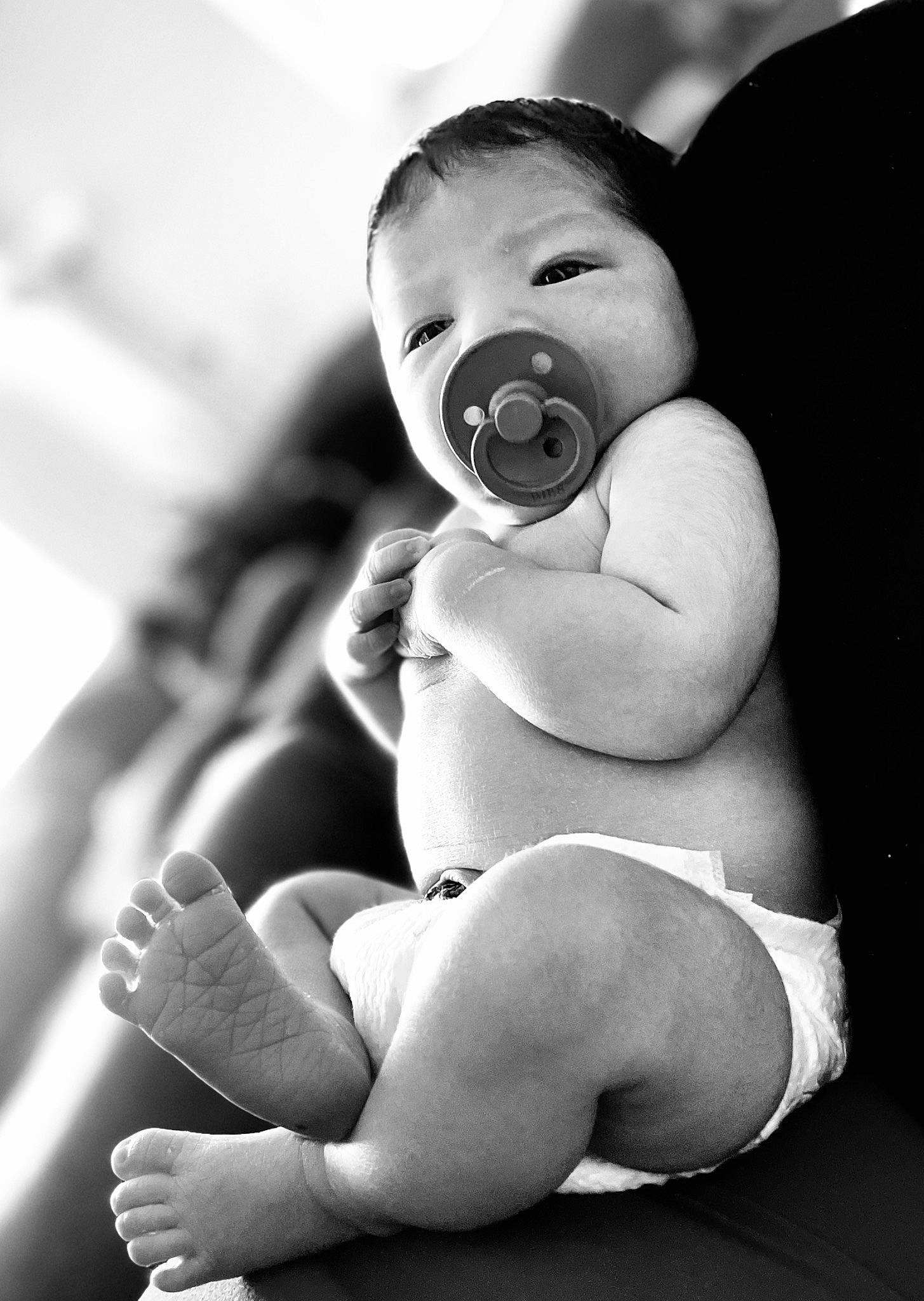 Koa joined the competition — help win amazing prizes! baby, black, black_and_white, chest, comfort, elbow, eye, finger, flash_photography, gesture, hand, happy, human_body, knee, leg, mouth, neck, person, photograph, stomach