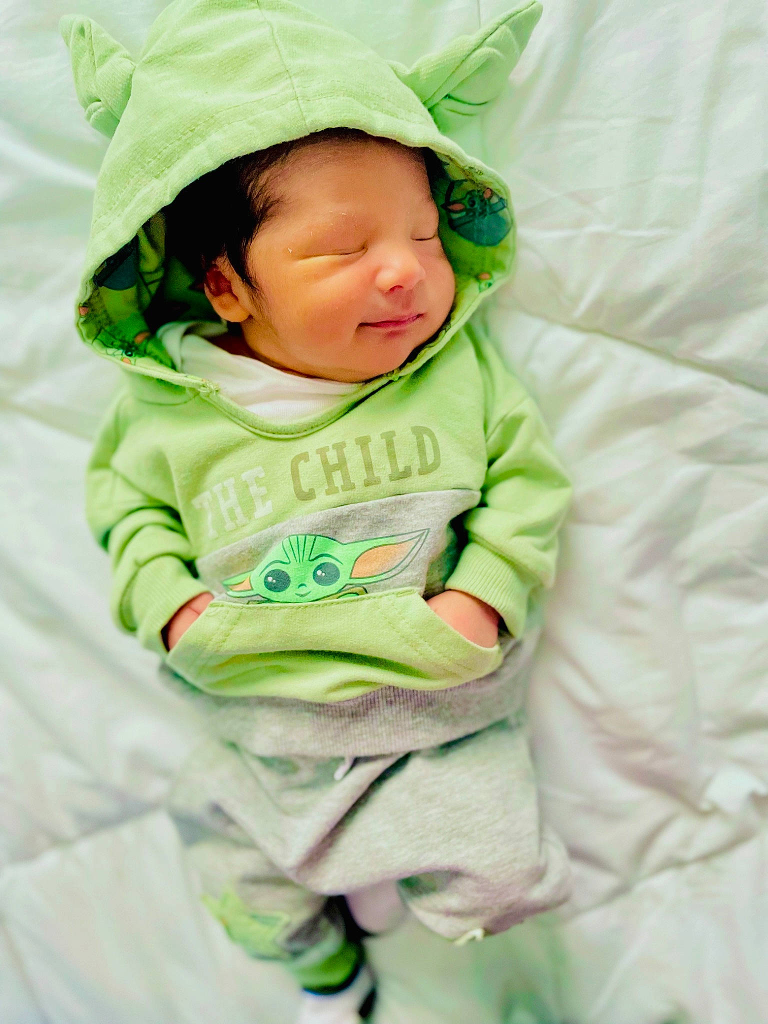 Koa joined the competition — help win amazing prizes! baby, baby_products, baby_toddler_clothing, cap, child, comfort, face, fashion_accessory, grass, happy, hat, linens, pattern, person, portrait_photography, sitting, sleeve, t_shirt, toddler