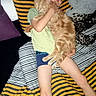 Grisou a rejoint le concours — aidez-le/la à gagner de superbes lots ! boy, cat, bed, striped_bedspread, orange_tabby, child, sleeping, hugging, pillow, blanket, indoor, comfort, resting, soft_toys, casual_clothing, relaxation, striped_pattern, happy, pet, cozy