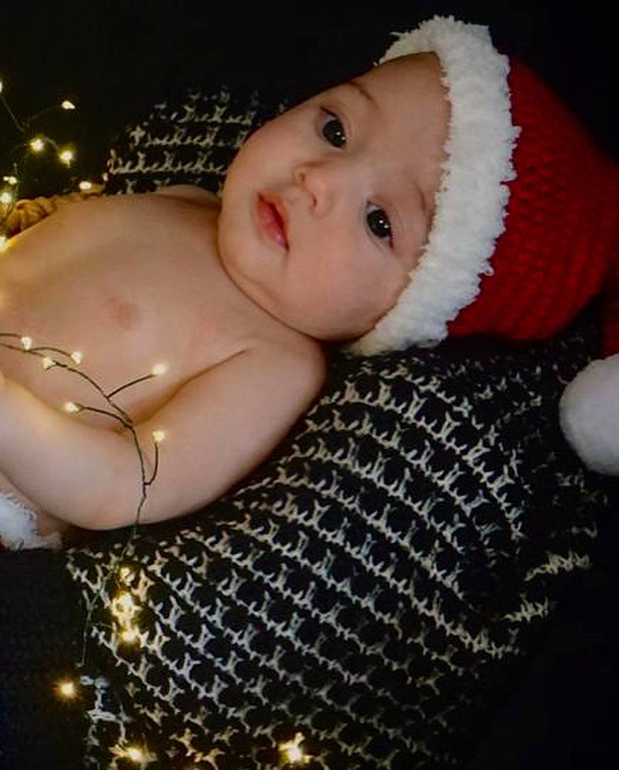 Natalia is registered to the contest to win money with this photo: abdomen, arm, baby, baby_toddler_clothing, cap, cheek, chest, child, eye, face, flash_photography, hand, headgear, headwear, iris, knit_cap, lip, pattern, person, skin