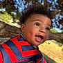 baby, child, smiling, outdoor, tree, curly_hair, striped_shirt, hand, grass, sunlight, person, happy, young_child, portrait, nature, daylight, skin, face, holding, blue_sky