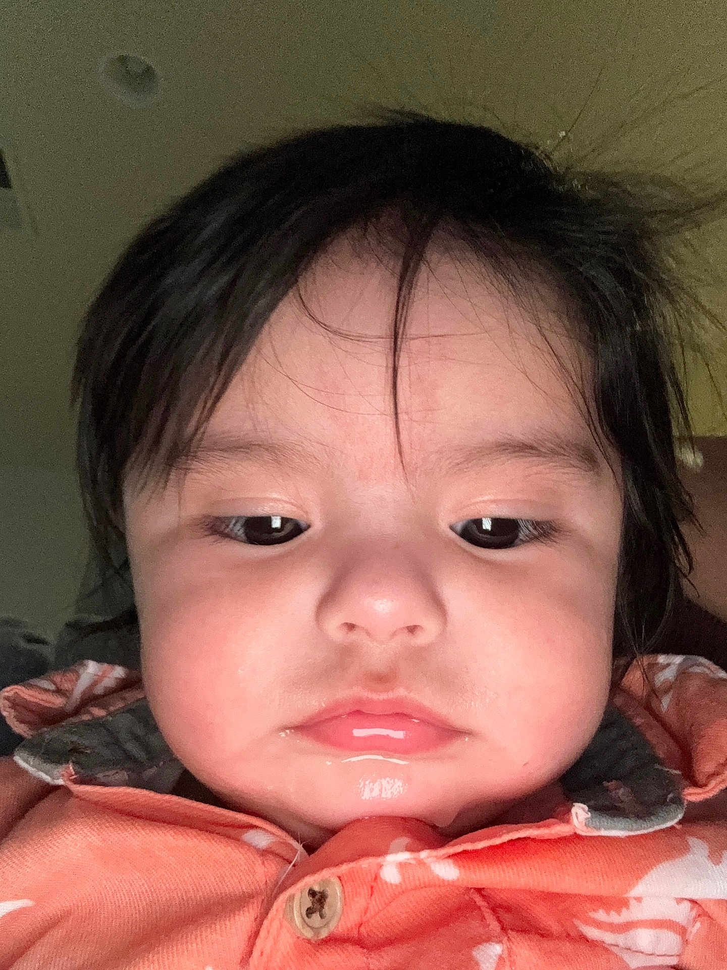 Malicah joined the competition — help win amazing prizes! child, toddler, face, close_up, portrait, indoor, hair, shirt, orange, expressionless, young_child, person, button, casual_clothing, skin, cheeks, eyelashes, eyebrows, head, young
