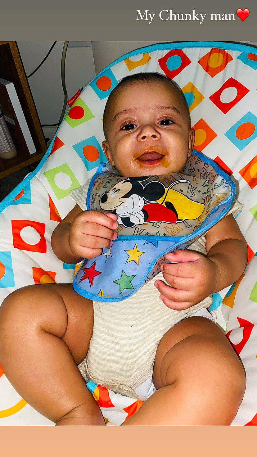 Garrett is registered to the contest to win money with this photo: arm, baby, baby_toddler_clothing, cheek, child, comfort, eye, finger, hairstyle, happy, head, human_body, iris, mouth, people, person, skin, stomach, textile, thigh