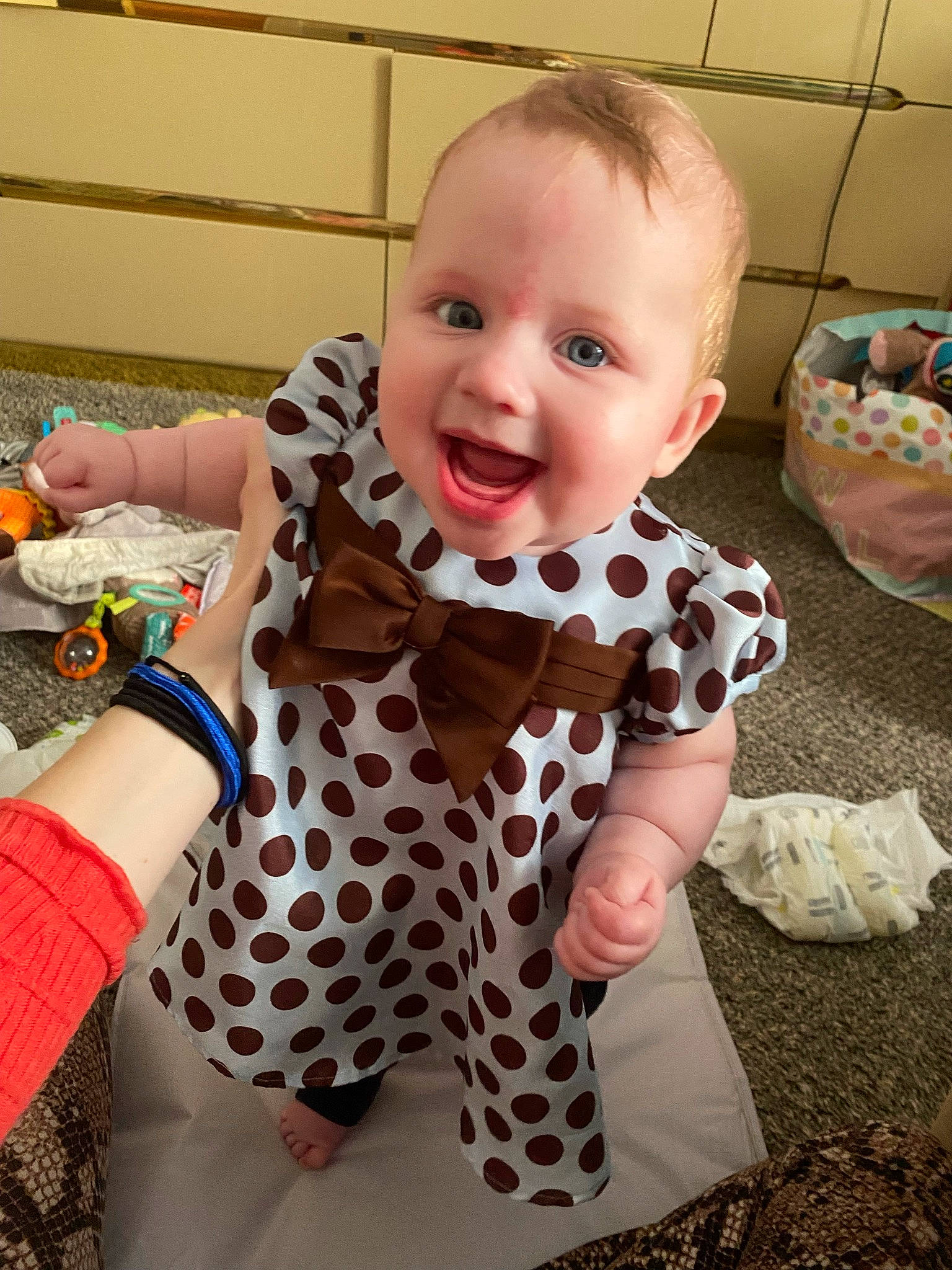 Kamila is registered to the contest to win money with this photo: arm, baby, baby_toddler_clothing, cheek, child, eye, face, finger, fun, happy, head, joint, nose, orange, pattern, person, skin, sleeve, smile, toddler