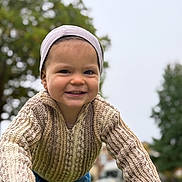 Tyson joined the competition — help win amazing prizes! beanie, blurred_background, casual_clothing, child, curious, cute, daylight, face, fall, happy, knitted_sweater, nature, outdoor, person, playground, portrait, smiling, toddler, trees, young_child