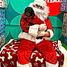dog, dachshund, santa_claus, christmas, holiday, festive, costume, red_suit, white_beard, wrapped_gifts, gift_wrap, present, pet, portrait, sitting, indoors, backdrop, blanket, paw_pattern, seasonal_decoration