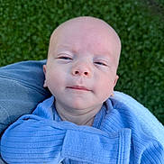 Fletcher joined the competition — help win amazing prizes! baby, infant, child, portrait, face, blue_clothing, blanket, outdoor, grass, sitting, lying_down, looking_at_camera, calm, expression, head, close_up, textile, denim, daylight, photography
