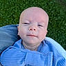 baby, infant, child, portrait, face, blue_clothing, blanket, outdoor, grass, sitting, lying_down, looking_at_camera, calm, expression, head, close_up, textile, denim, daylight, photography