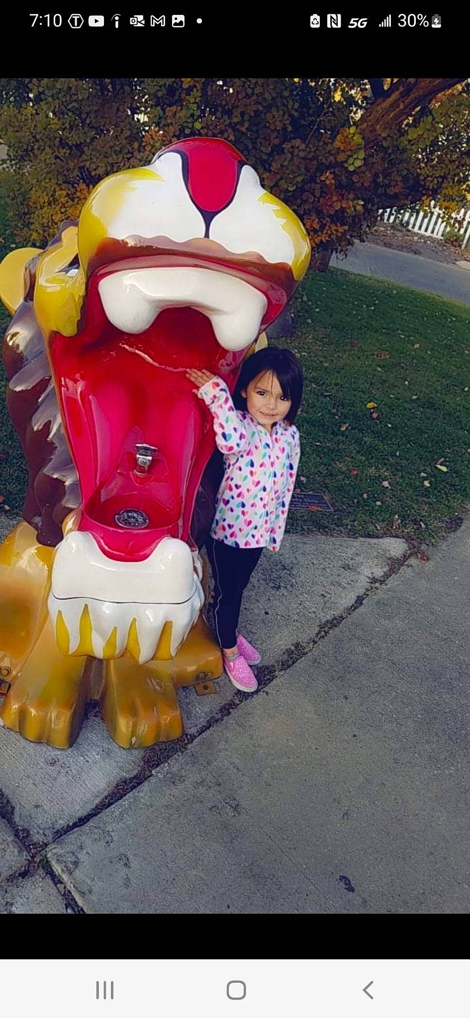 Isabella is registered to the contest to win money with this photo: asphalt, event, fictional_character, fun, grass, happy, jacket, joy, lawn_ornament, leisure, magenta, mascot, person, pink, plant, public_space, recreation, road_surface, santa_claus, toddler