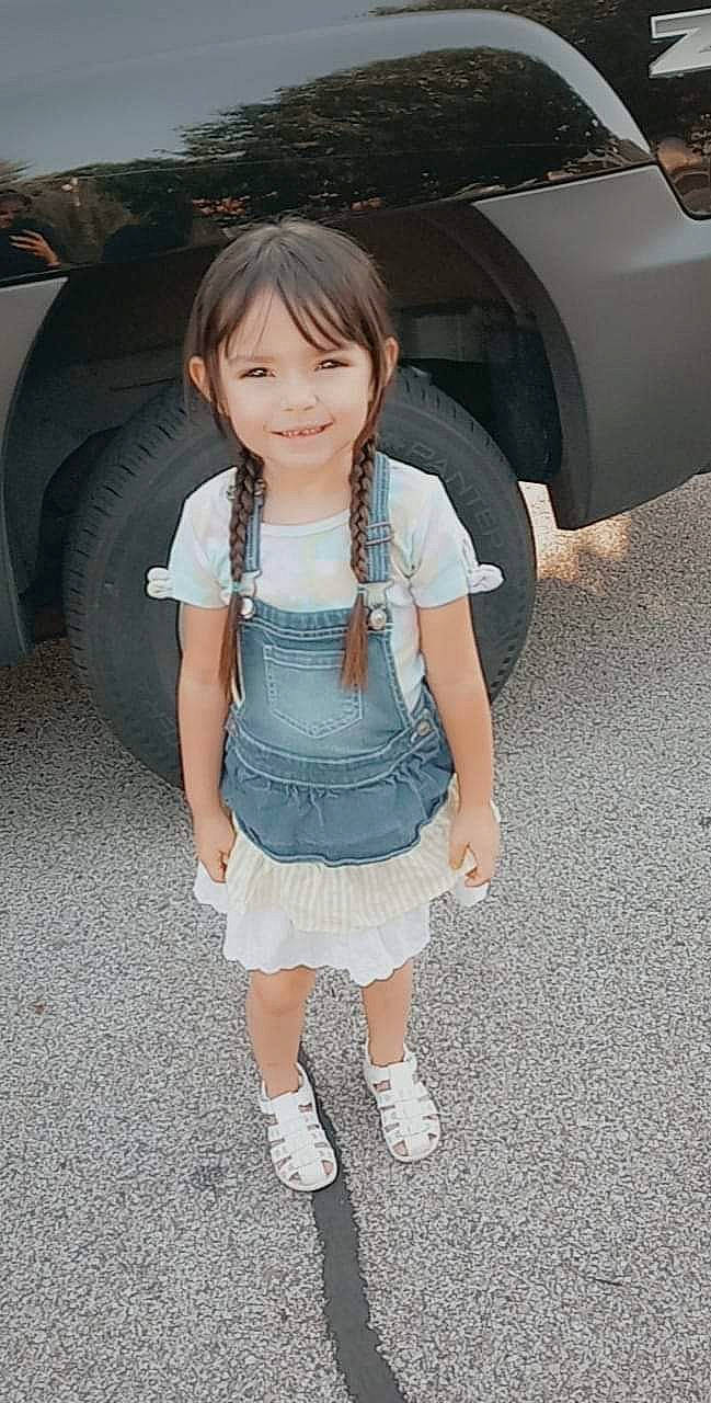 Isabella is registered to the contest to win money with this photo: automotive_exterior, automotive_lighting, automotive_tire, car, face, fender, hair, hairstyle, joy, leg, motor_vehicle, person, shoe, skin, sleeve, smile, sneakers, thigh, tire, vehicle_door