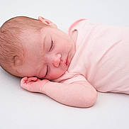 Luella is registered to the contest to win money with this photo: baby, newborn, sleeping, infant, pink_clothing, peaceful, resting, closeup, skin, hand, face, head, human, child, cute, soft_light, indoor, portrait, sleep, toddler