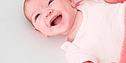 Luella joined the competition — help win amazing prizes! baby, infant, smiling, happy, lying_down, blanket, pink, clothing, face, skin, arm, hand, newborn, cute, child, soft_texture, closeup, portrait, expression, light_background