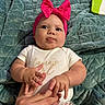 Lainey is registered to the contest to win money with this photo: baby, child, pink_bow, headband, white_shirt, mamas_girl_text, hands, fingers, quilted_blanket, floral_pants, tongue_out, cute, infant, indoor, portrait, soft_texture, playful, person, closeup, skin