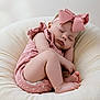 baby, child, closed_eyes, cushion, cute, headband, indoors, infant, peaceful, pink_bow, polka_dot, portrait, relaxed, resting, romper, sleep, sleeping, small_feet, soft_texture, toddler
