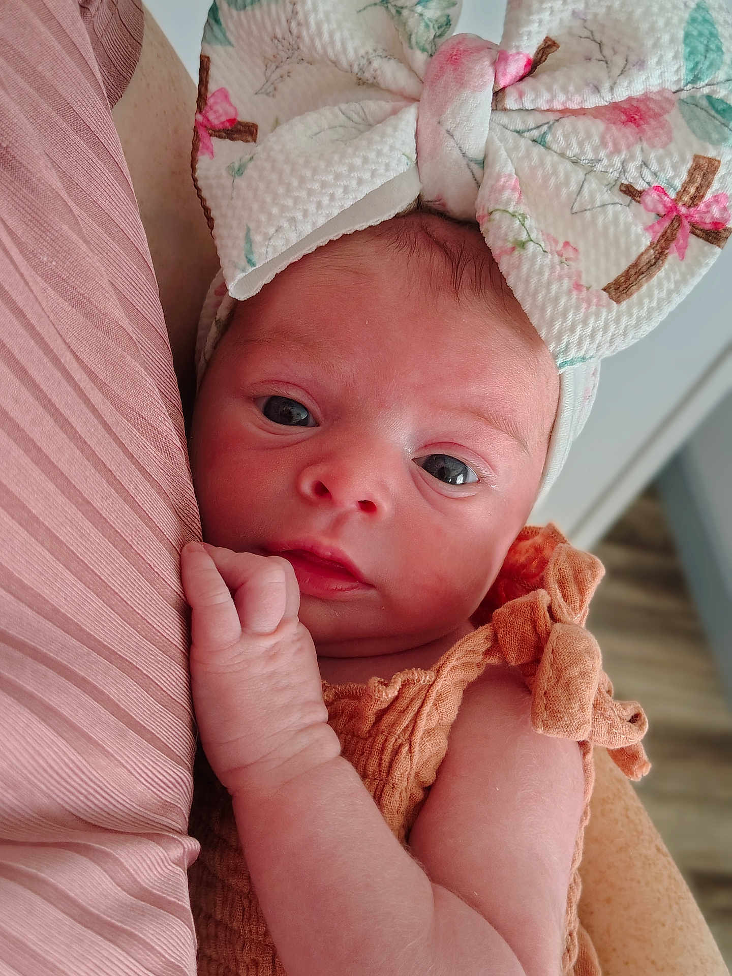 Charley joined the competition — help win amazing prizes! baby, newborn, infant, face, headband, bow, clothing, skin, hand, eyes, portrait, closeup, cute, soft, pink, orange, fabric, person, indoor, newborn_clothing