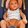 Jasai is registered to the contest to win money with this photo: baby, infant, car_seat, hat, clothing, socks, child, cute, portrait, smiling, indoors, seatbelt, warning_label, timberland, skin, hand, footwear, baby_clothes, headwear, child_safety