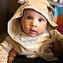 Jasai is registered to the contest to win money with this photo: baby, hoodie, ears, face, blue_eyes, child, portrait, clothing, person, cute, expression, indoor, skin, hand, holding, gold_chain, zipper, curious, warm_lighting, soft_texture