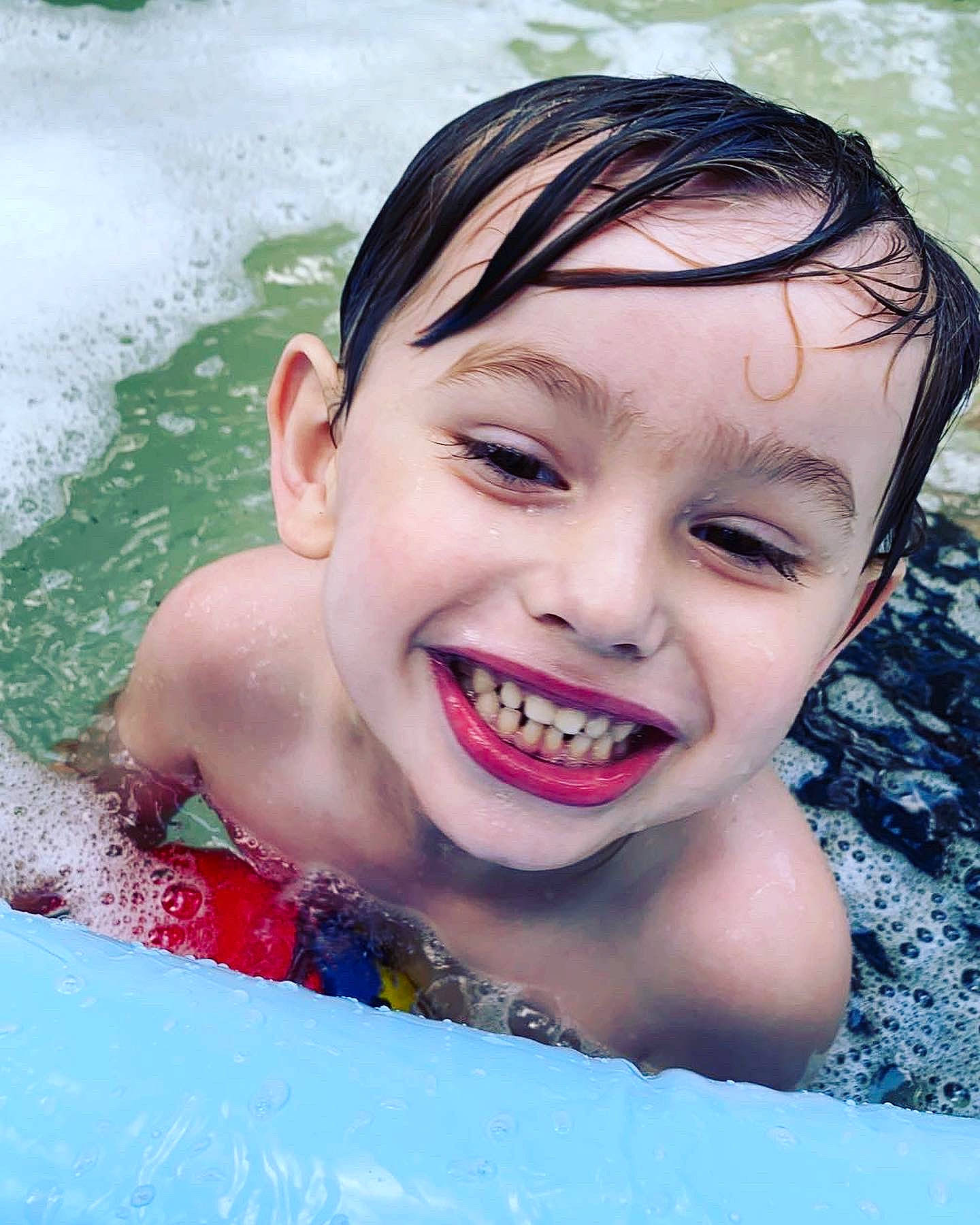 Ryan is registered to the contest to win money with this photo: azure, bathing, black_hair, child, eyebrow, eyelash, facial_expression, flash_photography, fun, happy, headwear, jaw, joy, leisure, lip, nose, person, recreation, skin, smile
