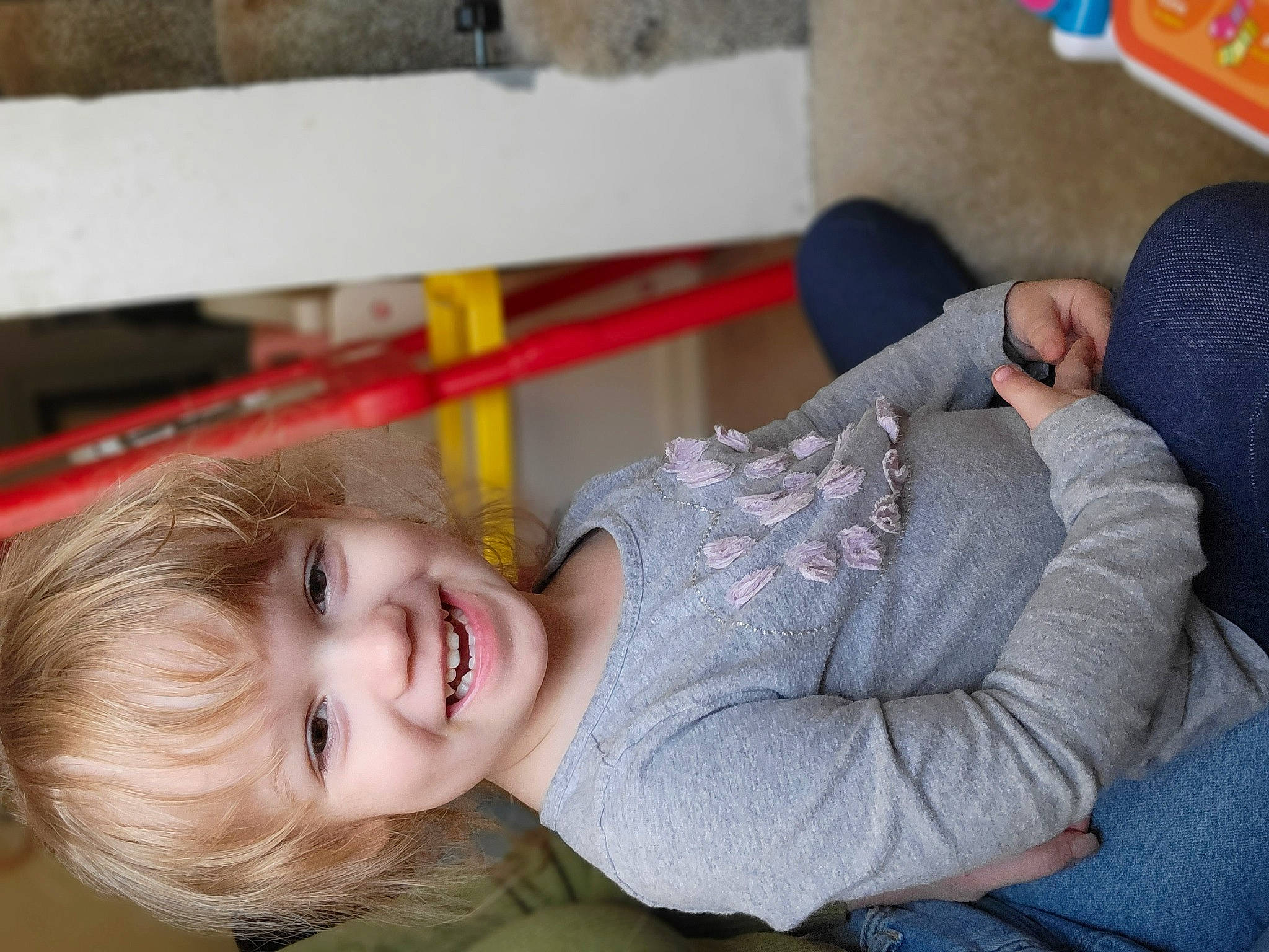 Peyton is registered to the contest to win money with this photo: baby, cheek, child, comfort, fun, happy, joy, laugh, leisure, person, play, portrait_photography, room, sitting, skin, smile, toddler, tree