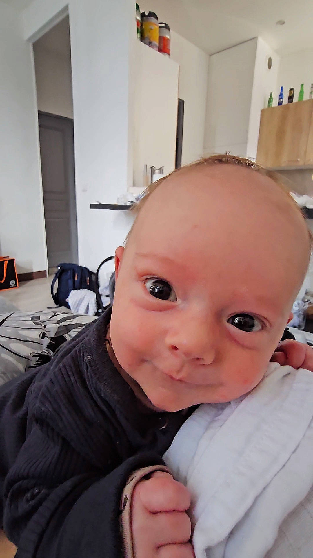 Nate participe au concours pour gagner de l'argent avec cette photo : baby, baby_toddler_clothing, chair, cheek, child, ear, eyebrow, eyelash, flooring, gesture, happy, nose, person, room, sitting, skin, sleeve, smile, thumb, toddler