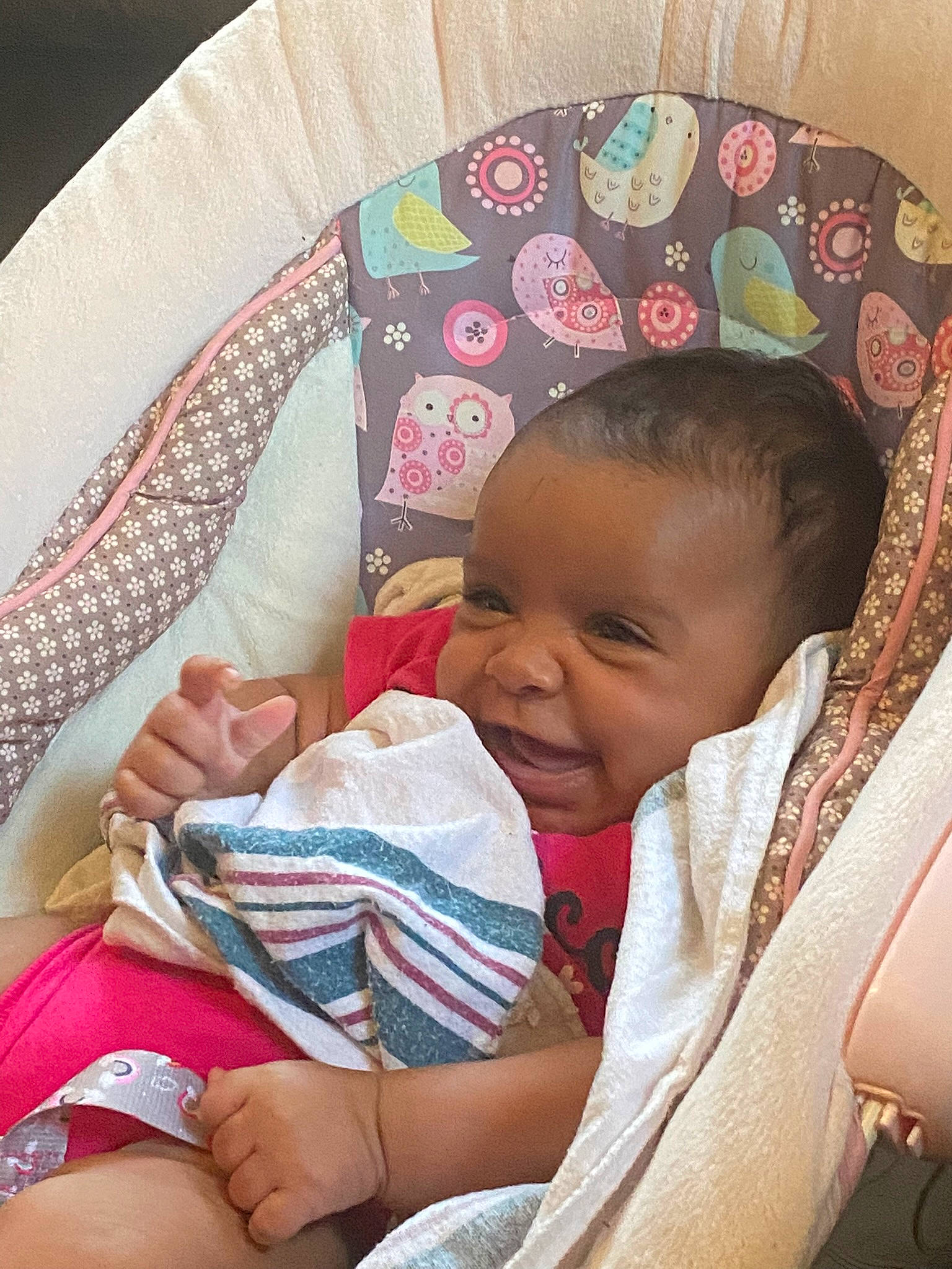 Jazmyn is registered to the contest to win money with this photo: baby, baby_toddler_clothing, cheek, child, comfort, event, fashion_accessory, happy, lap, linens, pattern, person, pink, product, room, sitting, skin, smile, textile, thigh