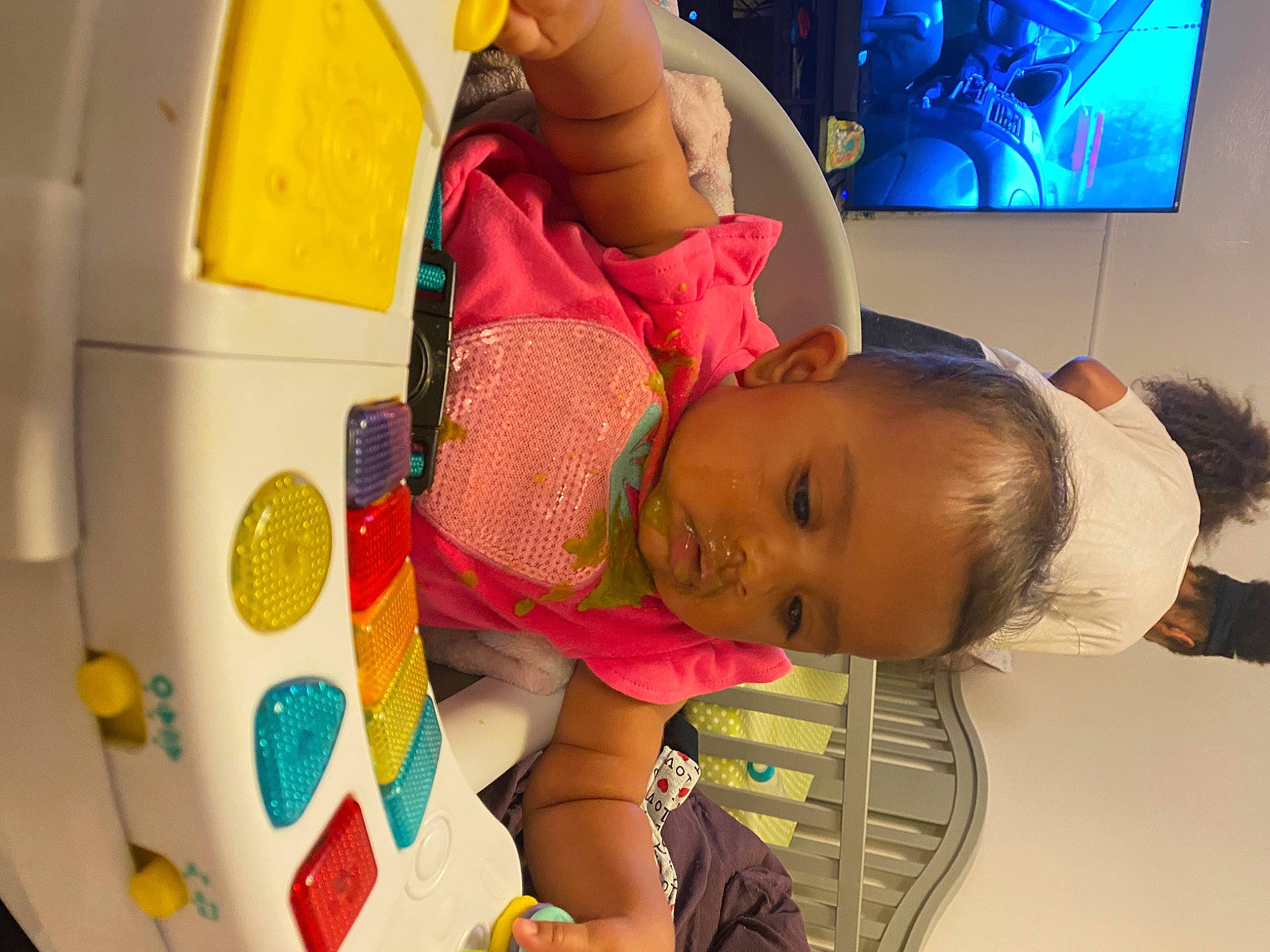 Jazmyn is registered to the contest to win money with this photo: baby, baby_products, baby_toys, child, comfort, display_device, fun, happy, home_appliance, learning, led_backlit_lcd_display, leisure, person, play, room, t_shirt, television, television_set, toddler, toy