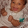 Jalaia is registered to the contest to win money with this photo: baby, infant, smiling, onesie, blanket, pacifier, face, happy, child, portrait, indoor, cute, cozy, skin, hand, lying_down, expression, young, person, digital_screen