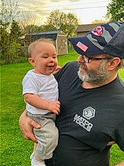 Chad joined the competition — help win amazing prizes! baby, baby_toddler_clothing, baseball_cap, beard, cap, child, event, fun, gesture, grass, happy, hat, headwear, leisure, people_in_nature, person, plant, recreation, sleeve, t_shirt