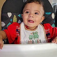 Bentley joined the competition — help win amazing prizes! baby, bib, child, clothing, cute, drool, expression, face, feeding, furniture, happy, high_chair, indoor, mealtime, person, portrait, red_shirt, seat, smiling, toddler